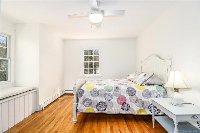 19 Fairchild Rd, Newtown, CT 06470 - bedroom with baseboard heating, light wood-style floors, and a ceiling fan