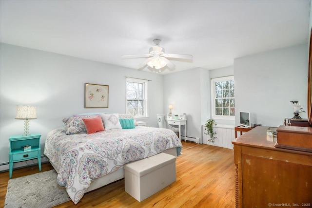 19 Fairchild Rd, Newtown, CT 06470 - bedroom featuring a baseboard heating unit, light wood finished floors, and multiple windows