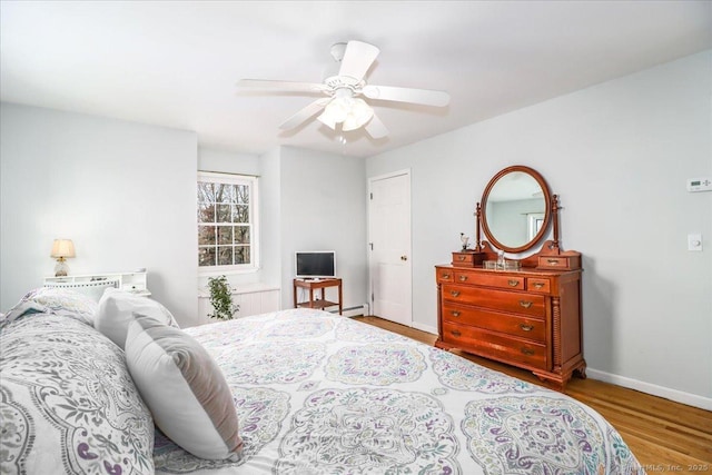 19 Fairchild Rd, Newtown, CT 06470 - bedroom featuring a baseboard heating unit, baseboards, wood finished floors, and ceiling fan