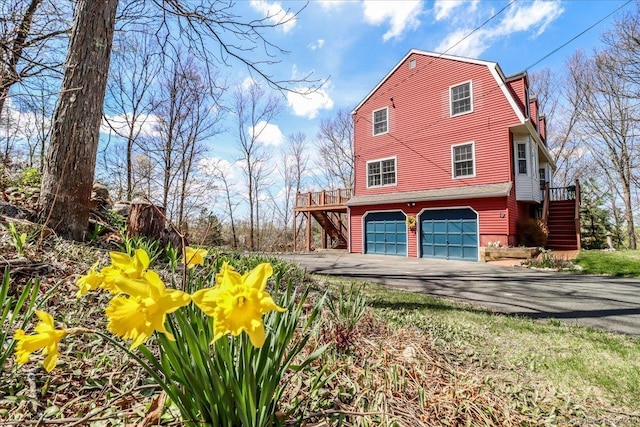 19 Fairchild Rd, Newtown, CT 06470 - view of property exterior featuring a garage, driveway, and stairs