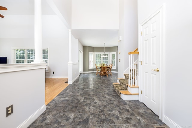 176 Fox Hollow Ln, Bristol, CT 06010 - foyer featuring ornate columns, stone finish floors, stairway, ceiling fan, and baseboards