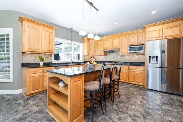 176 Fox Hollow Ln, Bristol, CT 06010 - kitchen featuring stainless steel appliances, light brown cabinetry, a center island, healthy amount of natural light, and recessed lighting