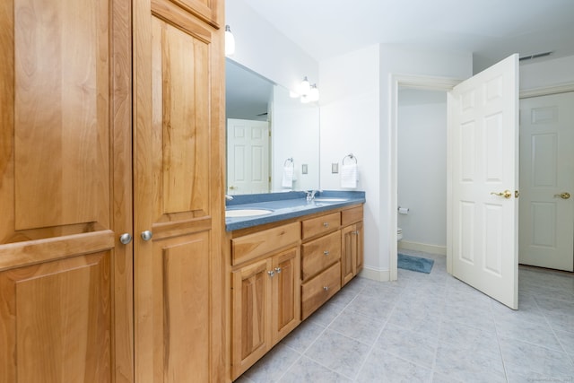 176 Fox Hollow Ln, Bristol, CT 06010 - bathroom featuring double vanity, tile patterned floors, and toilet