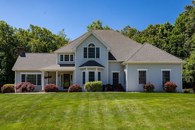 176 Fox Hollow Ln, Bristol, CT 06010 - view of front of property with a chimney, a front lawn, and a shingled roof