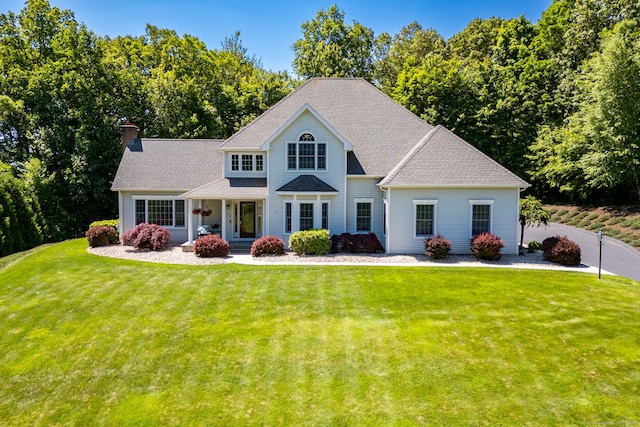 176 Fox Hollow Ln, Bristol, CT 06010 - view of front facade with a chimney, a front lawn, and a shingled roof