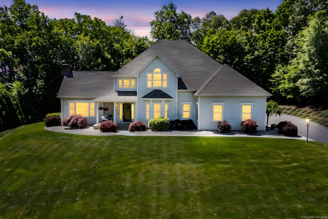 176 Fox Hollow Ln, Bristol, CT 06010 - rear view of house featuring a yard, a chimney, and covered porch