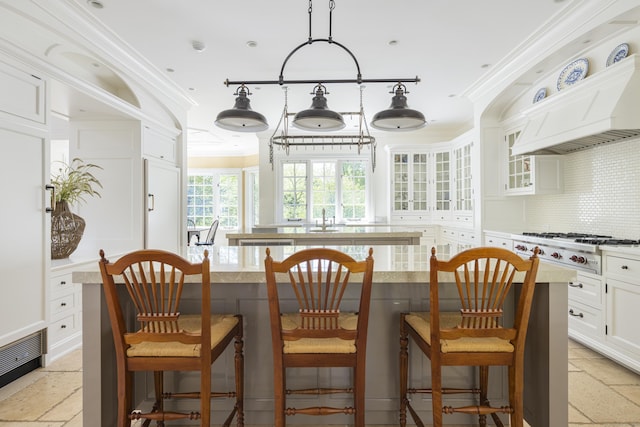 dining room featuring ornamental molding and stone tile floors