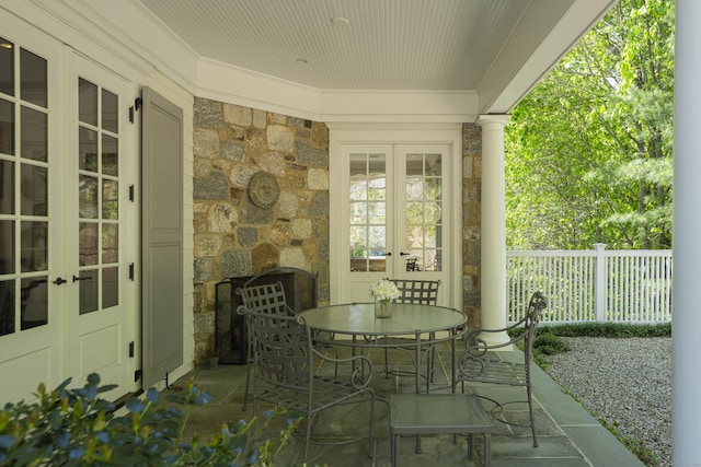view of patio featuring french doors, fence, and outdoor dining area