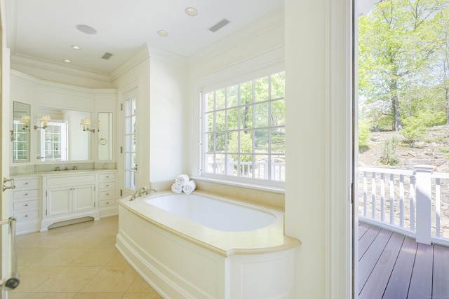 full bathroom with ornamental molding, vanity, a bath, and tile patterned floors