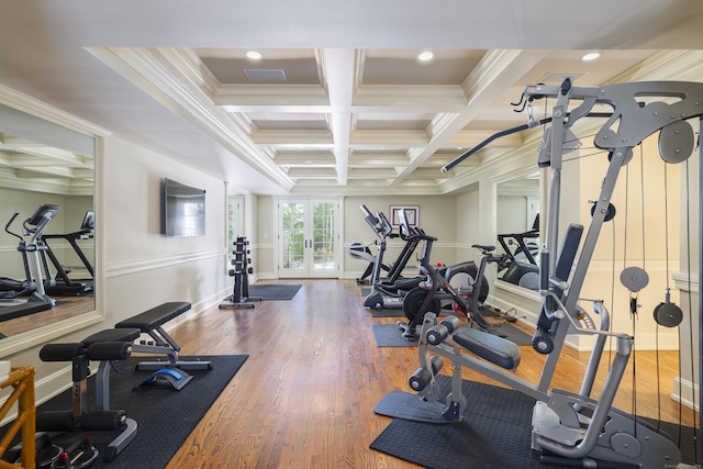 gym featuring ornamental molding, coffered ceiling, baseboards, wood finished floors, and beamed ceiling