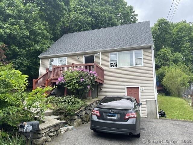 198 Charles St, Waterbury, CT 06708 - view of front of house featuring a deck, roof with shingles, driveway, and an attached garage