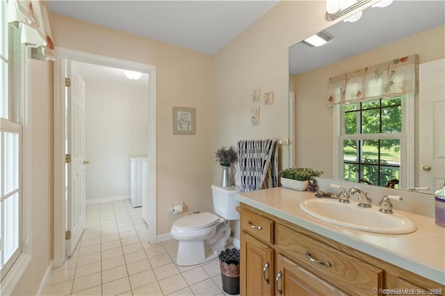 bathroom featuring vanity, baseboards, tile patterned floors, and toilet