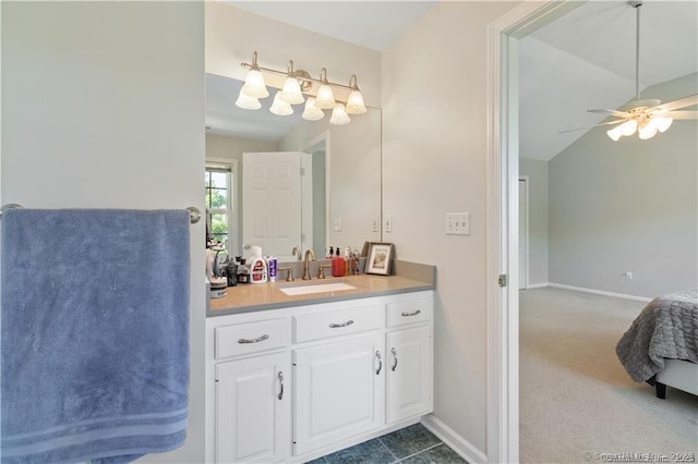 bathroom featuring ceiling fan, baseboards, lofted ceiling, and vanity