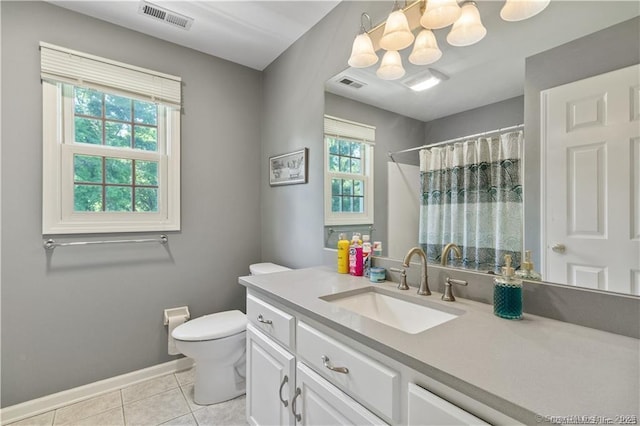 bathroom featuring a healthy amount of sunlight, tile patterned flooring, toilet, and visible vents