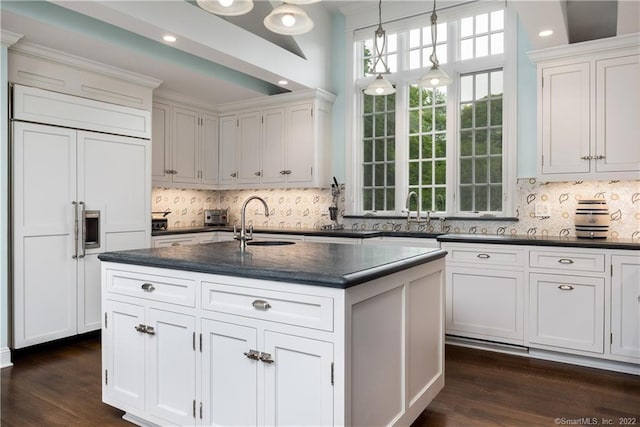 229 Umpawaug Rd, Redding, CT 06896 - kitchen with paneled fridge, a sink, white cabinetry, dark wood-style floors, and recessed lighting
