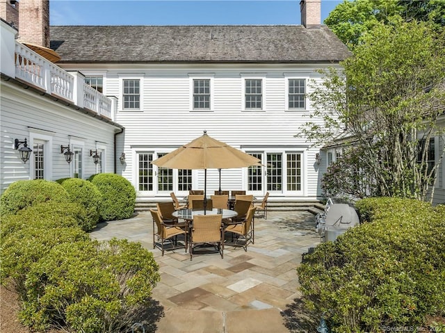 229 Umpawaug Rd, Redding, CT 06896 - rear view of property with a chimney, a patio, and outdoor dining area