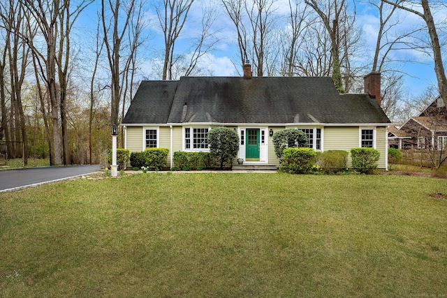 33 Riverview Dr, Norwalk, CT 06850 - new england style home with a chimney, fence, a front lawn, and driveway