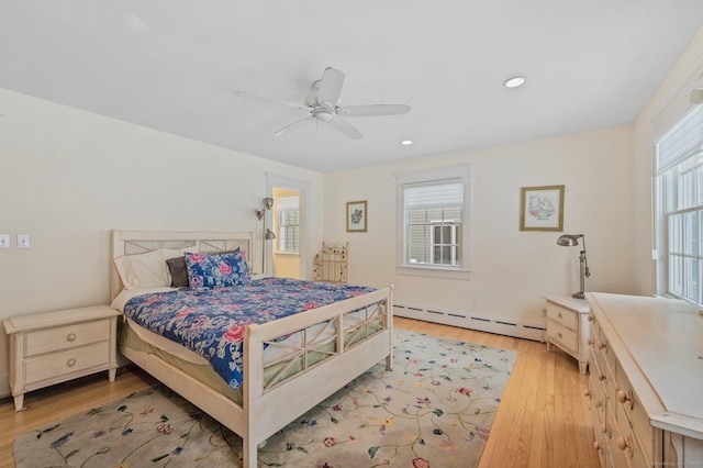 bedroom featuring baseboard heating, recessed lighting, a ceiling fan, and light wood-style flooring