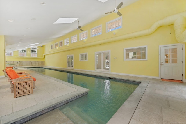 indoor pool featuring a skylight and ceiling fan