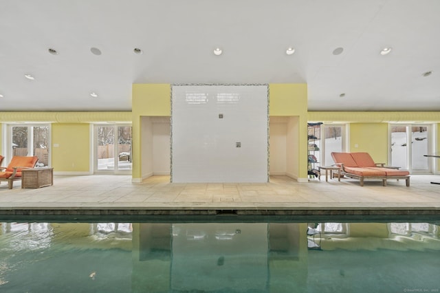 interior space with stucco siding, french doors, a community pool, and a patio