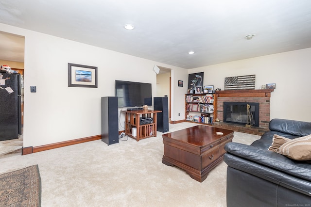 living area with baseboards, light carpet, a fireplace, and recessed lighting