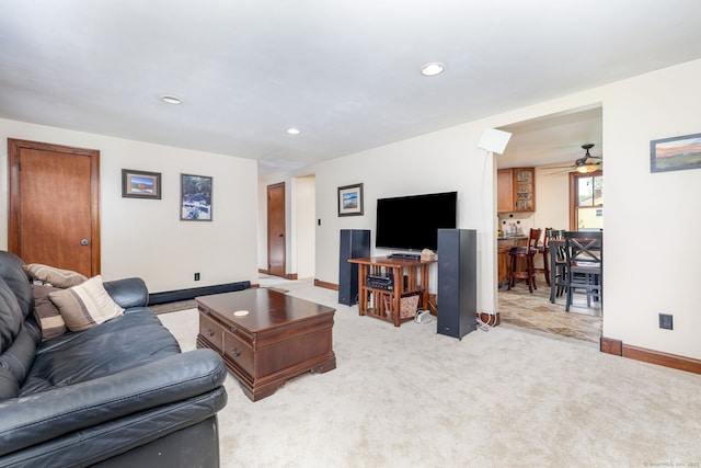 living area with baseboards, recessed lighting, light carpet, and ceiling fan