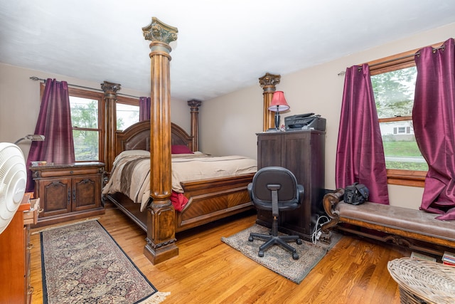 bedroom featuring light wood finished floors and multiple windows