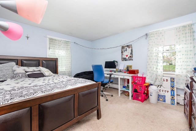 bedroom featuring light carpet