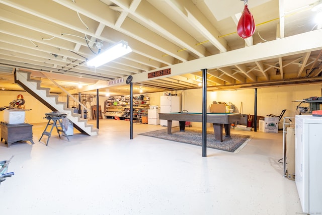 basement with freestanding refrigerator, stairway, washer / dryer, and pool table