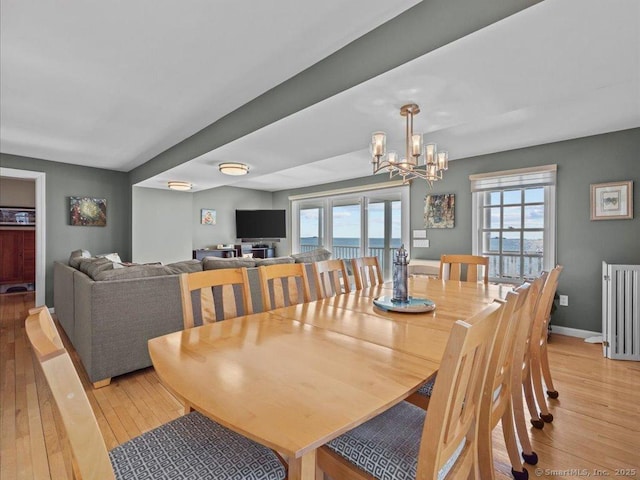 50 Grove Way, Clinton, CT 06413 - dining area with a chandelier, light wood-type flooring, and a healthy amount of sunlight