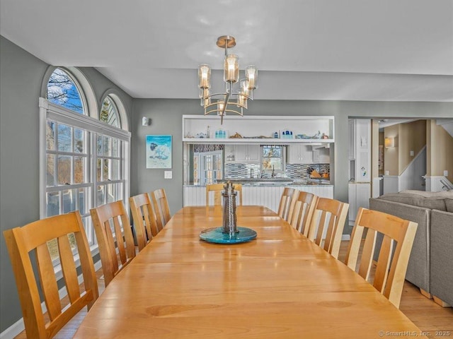50 Grove Way, Clinton, CT 06413 - dining space with a healthy amount of sunlight, light wood finished floors, and an inviting chandelier