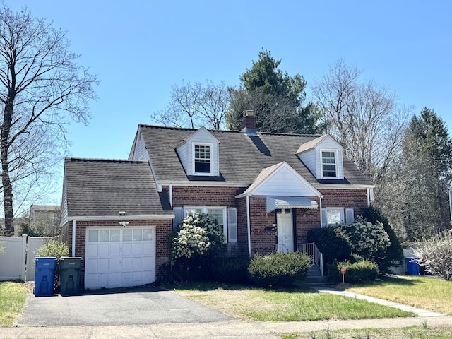 136 Oberlin Rd, Hamden, CT 06514 - cape cod house with a front lawn, driveway, a chimney, brick siding, and an attached garage