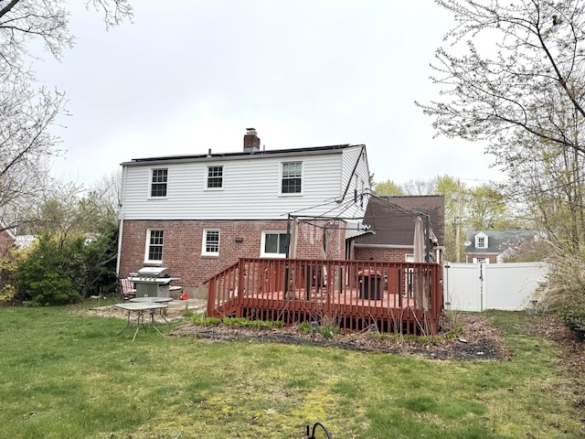136 Oberlin Rd, Hamden, CT 06514 - back of house featuring a chimney, fence, a yard, a wooden deck, and brick siding