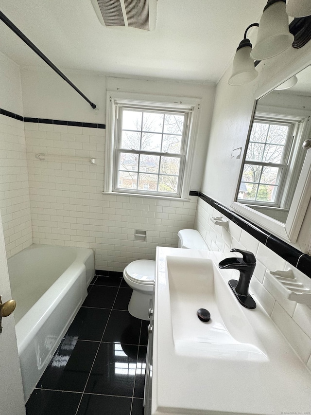 136 Oberlin Rd, Hamden, CT 06514 - bathroom with tile walls, a wealth of natural light, and tile patterned floors