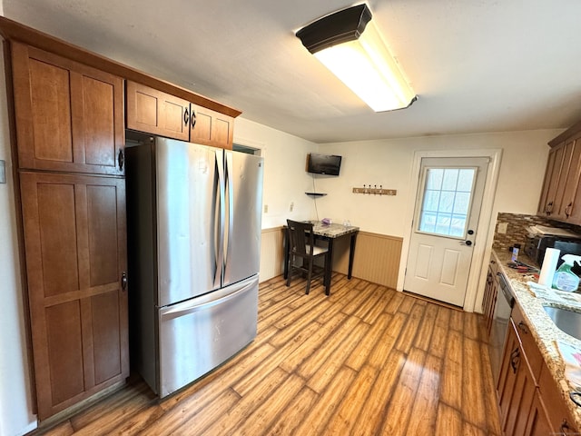 136 Oberlin Rd, Hamden, CT 06514 - kitchen with a sink, light wood finished floors, stainless steel appliances, and wainscoting