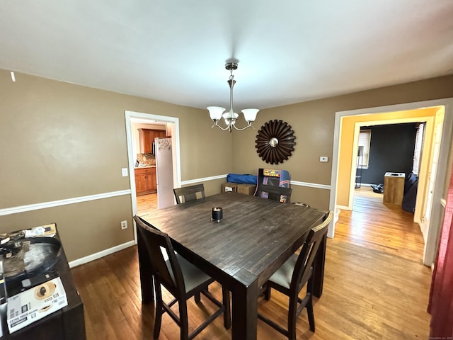 136 Oberlin Rd, Hamden, CT 06514 - dining room with light wood-type flooring, baseboards, and a notable chandelier