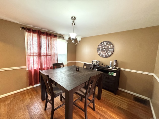 136 Oberlin Rd, Hamden, CT 06514 - dining room featuring wood finished floors, baseboards, and a notable chandelier