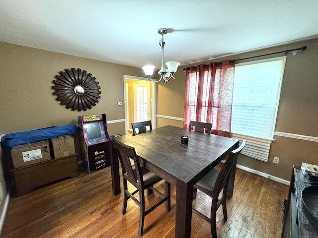 136 Oberlin Rd, Hamden, CT 06514 - dining space with baseboards, a chandelier, and wood-type flooring