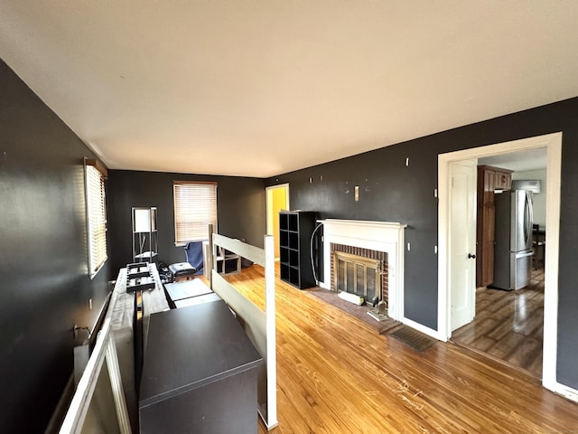 136 Oberlin Rd, Hamden, CT 06514 - exercise area featuring baseboards, wood finished floors, and a brick fireplace