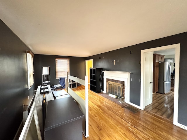 136 Oberlin Rd, Hamden, CT 06514 - workout area with baseboards, wood finished floors, and a fireplace