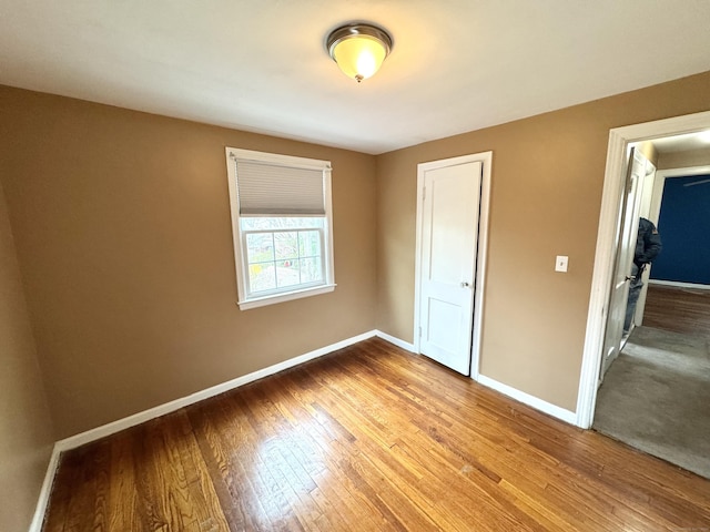 136 Oberlin Rd, Hamden, CT 06514 - unfurnished bedroom with wood finished floors, baseboards, and a closet