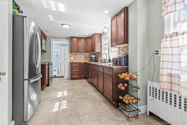116 Gaylord Dr, Waterbury, CT 06708 - kitchen with radiator heating unit, backsplash, light tile patterned floors, a sink, and appliances with stainless steel finishes