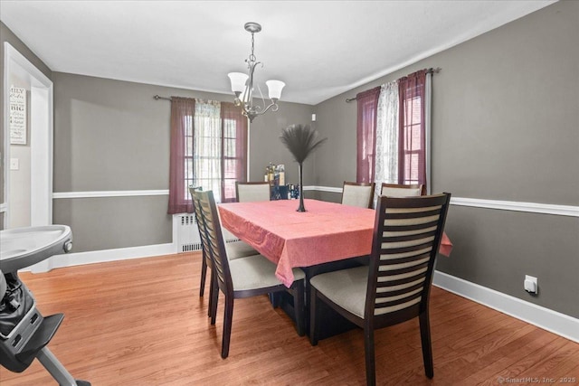 116 Gaylord Dr, Waterbury, CT 06708 - dining room with radiator, baseboards, wood finished floors, and a chandelier
