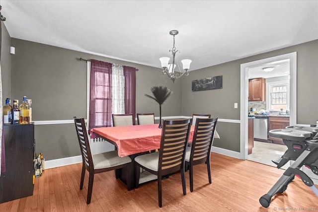 116 Gaylord Dr, Waterbury, CT 06708 - dining area featuring light wood-style floors, baseboards, and a notable chandelier