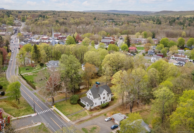 birds eye view of property featuring a view of trees