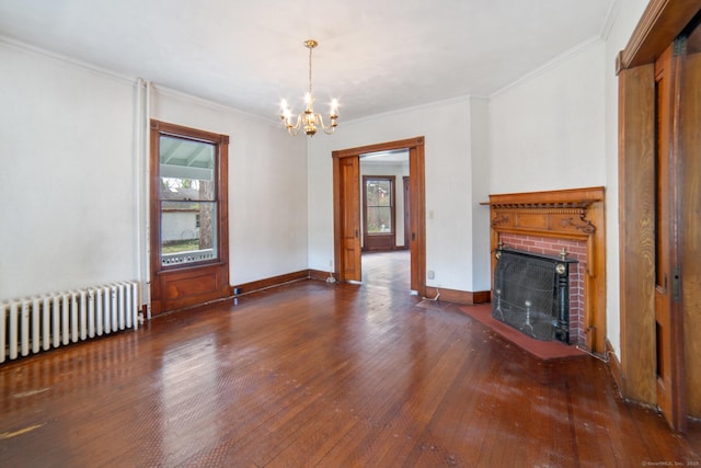 unfurnished living room with radiator, hardwood / wood-style floors, a chandelier, and a fireplace