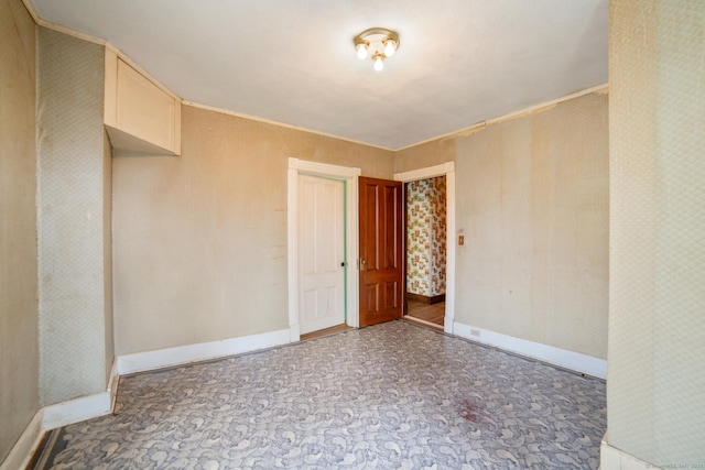 empty room featuring baseboards
