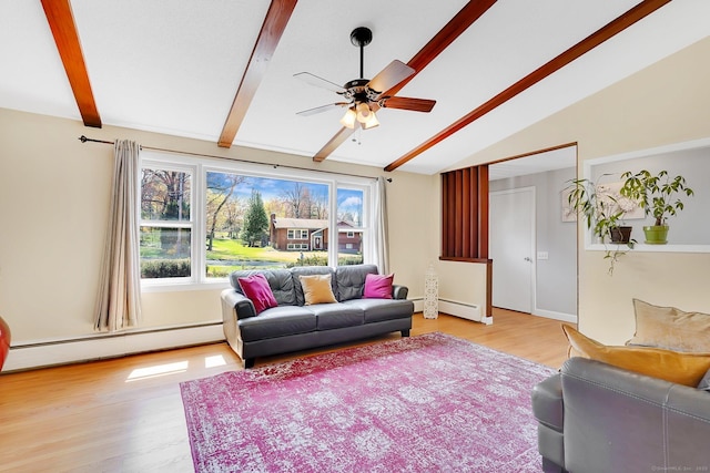 living room featuring a ceiling fan, wood finished floors, plenty of natural light, and vaulted ceiling with beams