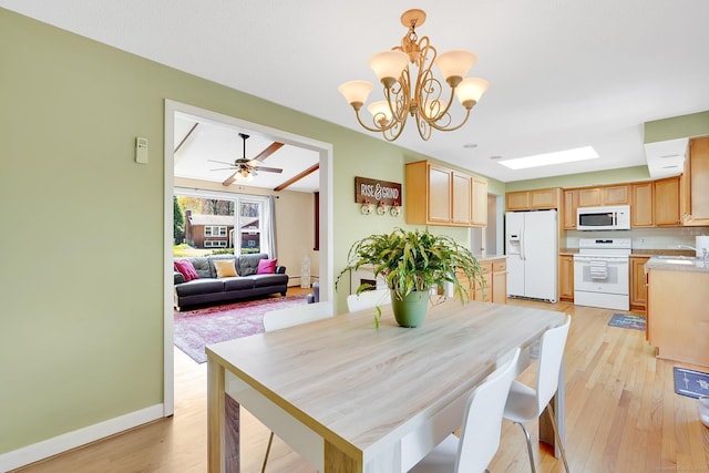 dining room featuring baseboards, ceiling fan with notable chandelier, light wood finished floors, and a baseboard radiator