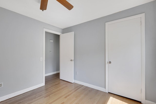 unfurnished bedroom featuring a ceiling fan, wood finished floors, and baseboards